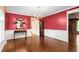 Formal living room with hardwood floors, a decorative mirror and adjacent room at 3123 Amherst Ave, Burlington, NC 27215