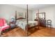 Spacious main bedroom features a four-poster bed, hardwood floors, and ample natural light at 3123 Amherst Ave, Burlington, NC 27215