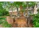Charming brick patio featuring outdoor seating, an iron railing, and a view of the home's exterior at 3123 Amherst Ave, Burlington, NC 27215