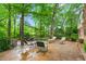 Inviting brick patio surrounded by lush greenery, perfect for outdoor relaxation and entertaining at 3123 Amherst Ave, Burlington, NC 27215