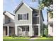 Charming two-story home with gray siding, black shutters, and a welcoming front porch with rocking chairs at 328 Cottage Hill Way, Raleigh, NC 27604