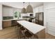 Spacious kitchen with stainless appliances, white cabinets, and a large center island with seating for four at 328 Cottage Hill Way, Raleigh, NC 27604