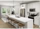 Modern kitchen with stainless steel appliances, a large island, and an adjacent dining area at 336 Cottage Hill Way, Raleigh, NC 27604