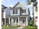 Charming two-story home with a cozy front porch, offering a welcoming curb appeal and a delightful outdoor space at 346 Cottage Hill Way, Raleigh, NC 27604