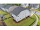 Aerial view of home with sunroom, black fencing, and manicured lawn in a well-maintained neighborhood at 348 Golf Vista Trl, Holly Springs, NC 27540
