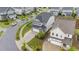 Lovely home with paved driveway, manicured lawn, sleek black fencing, and beautifully landscaped surroundings at 348 Golf Vista Trl, Holly Springs, NC 27540