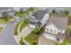 Aerial view of a well-situated home in a quiet neighborhood with manicured lawns and mature trees at 348 Golf Vista Trl, Holly Springs, NC 27540