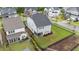 Aerial view of home with sunroom, black fencing, and manicured lawn in a well-maintained neighborhood at 348 Golf Vista Trl, Holly Springs, NC 27540