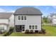Back exterior with lawn, black fencing, and sunroom at 348 Golf Vista Trl, Holly Springs, NC 27540