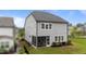 Back exterior featuring an enclosed sunroom, a well-manicured lawn, and sleek, black fencing at 348 Golf Vista Trl, Holly Springs, NC 27540