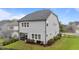 Back exterior featuring an enclosed sunroom, a well-manicured lawn, and sleek, black fencing at 348 Golf Vista Trl, Holly Springs, NC 27540