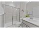 Bathroom featuring tiled glass shower, tile flooring, white toilet and vanity with brushed nickel plumbing at 348 Golf Vista Trl, Holly Springs, NC 27540