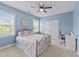 Charming bedroom featuring a cozy bed, two bright windows, and a dedicated workspace, ideal for relaxation and productivity at 348 Golf Vista Trl, Holly Springs, NC 27540