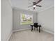 Bright bedroom with a ceiling fan, a window view, and a modern workspace setup with a black desk and chair at 348 Golf Vista Trl, Holly Springs, NC 27540
