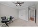 Cozy bedroom featuring a ceiling fan, plush carpeting, closet, and a desk perfect for a home office at 348 Golf Vista Trl, Holly Springs, NC 27540