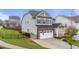 Charming two-story home featuring stone accents, a well-maintained yard, and a two-car garage at 348 Golf Vista Trl, Holly Springs, NC 27540