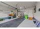 Clean garage with shelving for storage and ample space for vehicles and projects at 348 Golf Vista Trl, Holly Springs, NC 27540