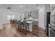 Kitchen island with bar stool seating, modern appliances, and an open floor plan at 348 Golf Vista Trl, Holly Springs, NC 27540