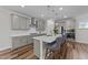 Kitchen island with quartz countertops, stainless steel appliances, and seating at 348 Golf Vista Trl, Holly Springs, NC 27540