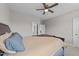 Spacious bedroom with a large bed, neutral decor, and a ceiling fan, creating a cozy and inviting atmosphere at 348 Golf Vista Trl, Holly Springs, NC 27540