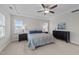 Main bedroom with a tray ceiling, carpet floors, and natural light at 348 Golf Vista Trl, Holly Springs, NC 27540