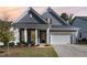 Charming home with a two-car garage, manicured lawn, and lovely curb appeal enhanced by a sunset at 362 Warm Wind Dr, Clayton, NC 27527