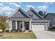 Charming home with manicured lawn, flower beds, and a two car garage at 362 Warm Wind Dr, Clayton, NC 27527