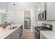 Modern kitchen with stainless steel appliances, quartz countertops and center island with bar stool seating at 362 Warm Wind Dr, Clayton, NC 27527