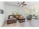 Bright living room featuring a ceiling fan, natural light, and comfortable seating arrangement at 362 Warm Wind Dr, Clayton, NC 27527