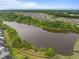 Aerial view of a community with a scenic lake surrounded by trees and walking paths at 3625 Bailey Lake Dr, Fuquay Varina, NC 27526