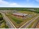 Aerial view of a community with a school, neighborhood homes, and greenery at 3625 Bailey Lake Dr, Fuquay Varina, NC 27526