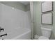 Clean bathroom featuring a bathtub with a shower, a toilet, and contemporary neutral tones at 3625 Bailey Lake Dr, Fuquay Varina, NC 27526
