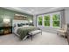 Stylish bedroom with a tray ceiling, green accent wall, and a large window view at 3625 Bailey Lake Dr, Fuquay Varina, NC 27526