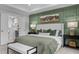 Stylish bedroom features a green accent wall, and an ensuite bathroom at 3625 Bailey Lake Dr, Fuquay Varina, NC 27526