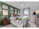 Charming bedroom featuring dark green accent wall, decorative artwork, and a comfortable bed at 3625 Bailey Lake Dr, Fuquay Varina, NC 27526