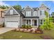Inviting two-story home showcasing a two-car garage, gray siding, manicured landscaping, and a charming front porch at 3625 Bailey Lake Dr, Fuquay Varina, NC 27526
