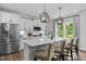 Stylish kitchen featuring white cabinets, a large island, and stainless steel appliances at 3625 Bailey Lake Dr, Fuquay Varina, NC 27526