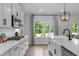 Well-lit kitchen showcasing a gas range, stainless appliances, and a view of the backyard at 3625 Bailey Lake Dr, Fuquay Varina, NC 27526