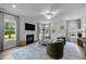 Bright living room boasts a cozy fireplace, stylish decor, and large windows for ample natural light at 3625 Bailey Lake Dr, Fuquay Varina, NC 27526