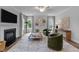 Bright living room boasts a cozy fireplace, stylish decor, and large windows for ample natural light at 3625 Bailey Lake Dr, Fuquay Varina, NC 27526