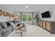 Comfortable living room with modern decor, large sofa, and ample natural light at 3625 Bailey Lake Dr, Fuquay Varina, NC 27526