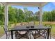 Outdoor patio with table and chairs showcases views of the backyard and surrounding trees at 3625 Bailey Lake Dr, Fuquay Varina, NC 27526