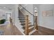 Elegant staircase features wood treads, black iron balusters, and natural light at 3625 Bailey Lake Dr, Fuquay Varina, NC 27526