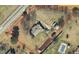 An aerial view of the property featuring a pool and expansive yard, surrounded by lush greenery and mature trees at 3627 Nc 57, Hillsborough, NC 27278