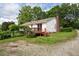 Backyard view with a small deck and gravel area at 3627 Nc 57, Hillsborough, NC 27278