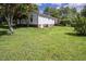 Expansive backyard features a well-maintained lawn, mature trees, and a charming garden area at 3627 Nc 57, Hillsborough, NC 27278