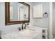 Bathroom with a marble countertop sink, a cabinet and a framed mirror above at 3627 Nc 57, Hillsborough, NC 27278