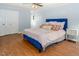 Spacious bedroom with wood floors, ceiling fan, closet and a blue bedframe with a quilt at 3627 Nc 57, Hillsborough, NC 27278