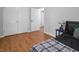 Bedroom features wood floors, a closet, a lamp and a bed at 3627 Nc 57, Hillsborough, NC 27278