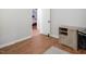 View of a bedroom with hardwood floors and a glimpse into the next room with a bed at 3627 Nc 57, Hillsborough, NC 27278